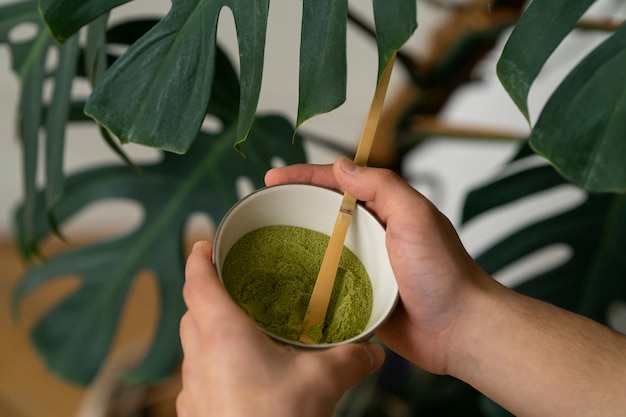 Free photo person having a cup of matcha tea