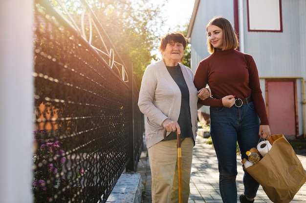 Free photo person helping their elder neighbour