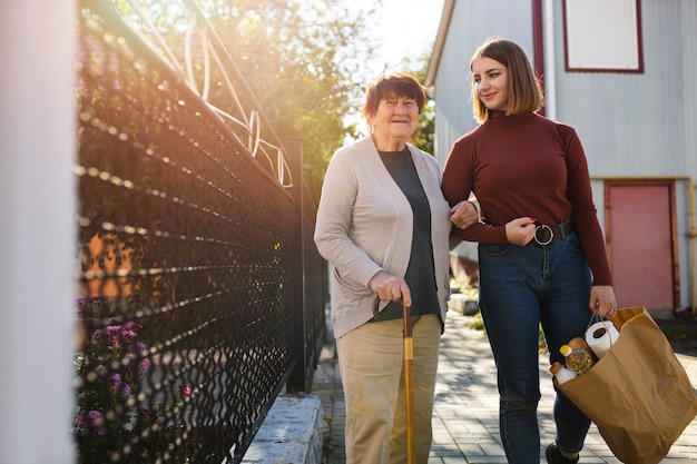 Person helping their elder neighbour