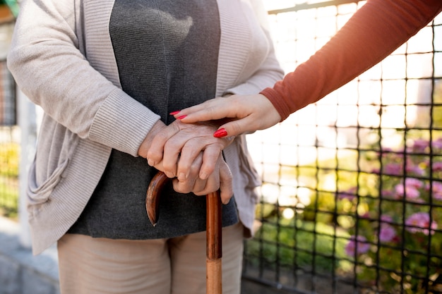 Person helping their elder neighbour