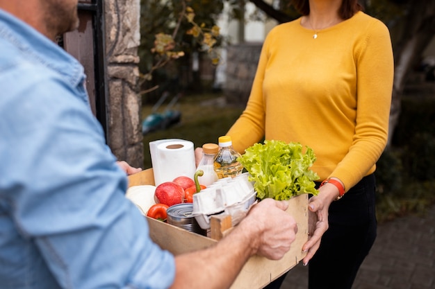 Person helping their neighbors with food