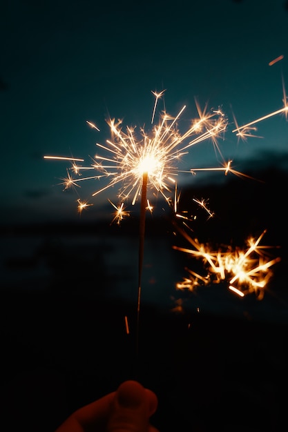 Free Photo person holding bengal lights or sparklers