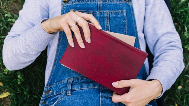 Person holding book on the grass