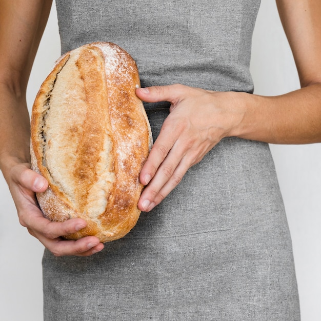 Person holding bread loaf