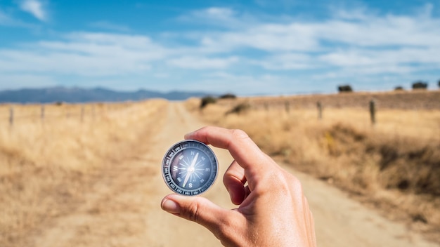 Free Photo person holding a compass during the daytime