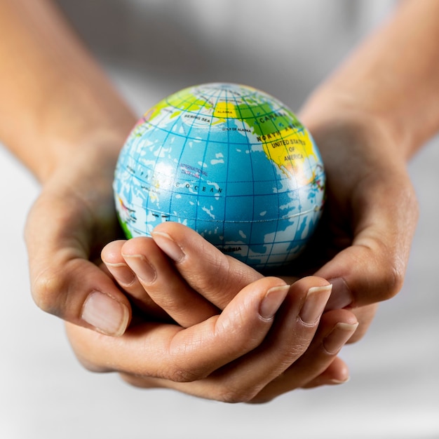 Free photo person holding earth globe