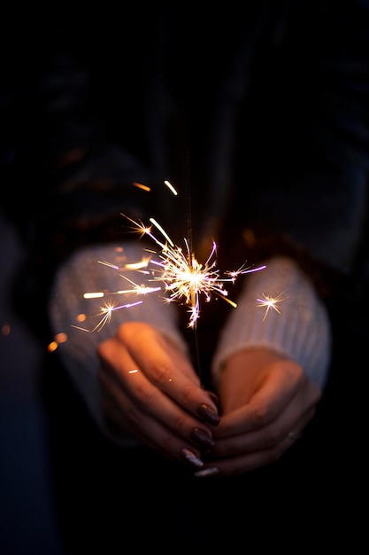 Free Photo person holding a festive sparkler