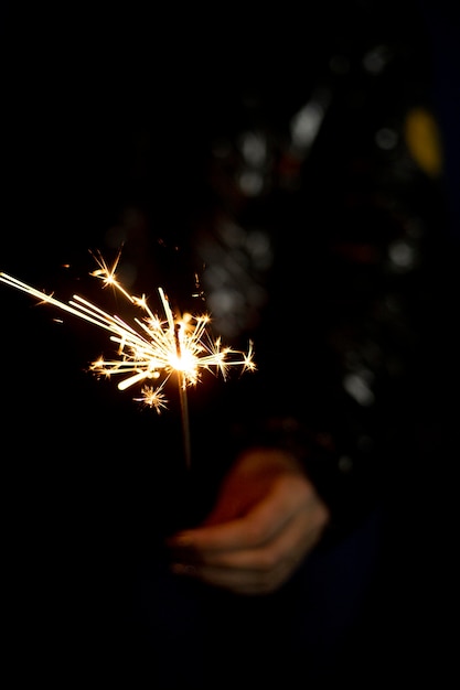 Free Photo person holding a festive sparkler