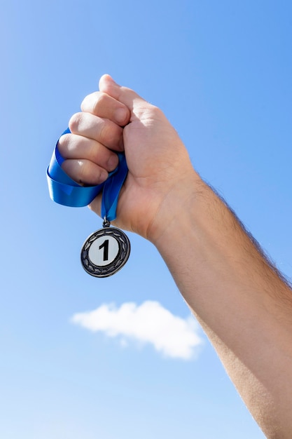 Person holding his number one medal