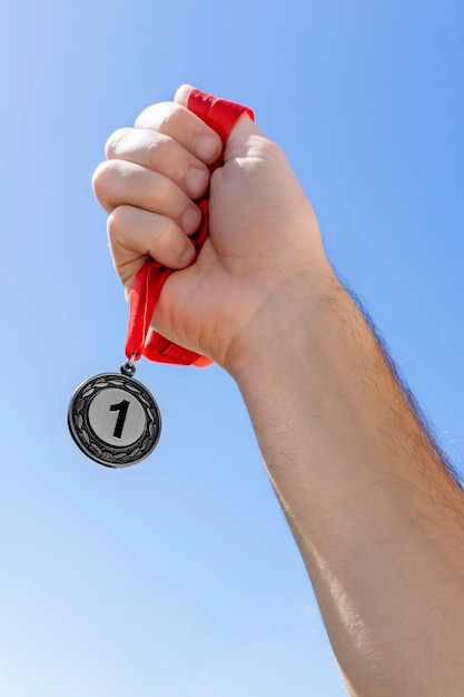 Person holding his number one medal