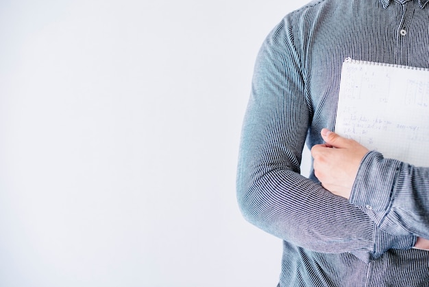 Person holding notebook in studio