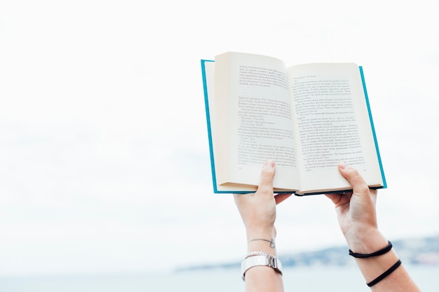 Person holding an open book