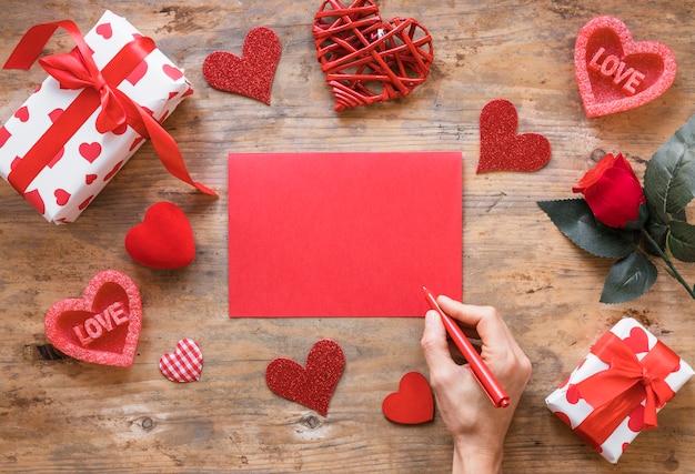 Free photo person holding pen above blank paper