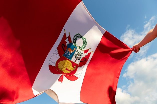 Person holding the peru flag outdoors