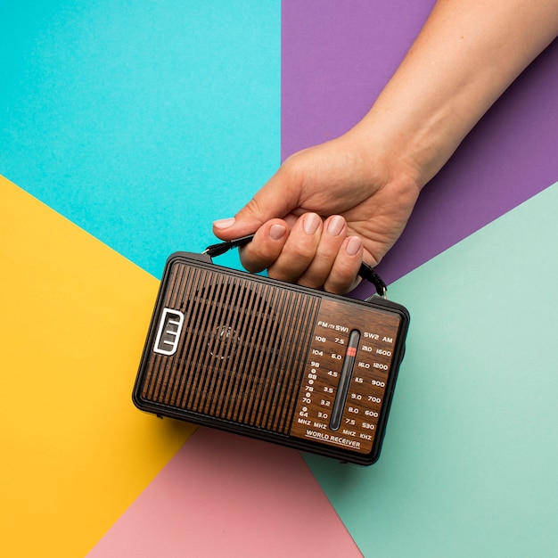 Person holding retro broadcast radio receiver