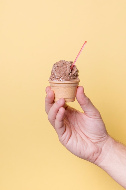 Free photo person holding scoop of ice cream in hand