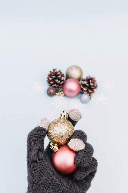 Person holding shiny baubles in hand