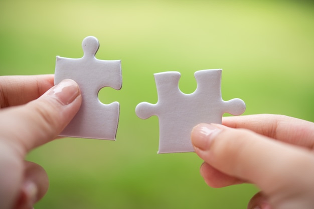 Person holding white puzzle pieces