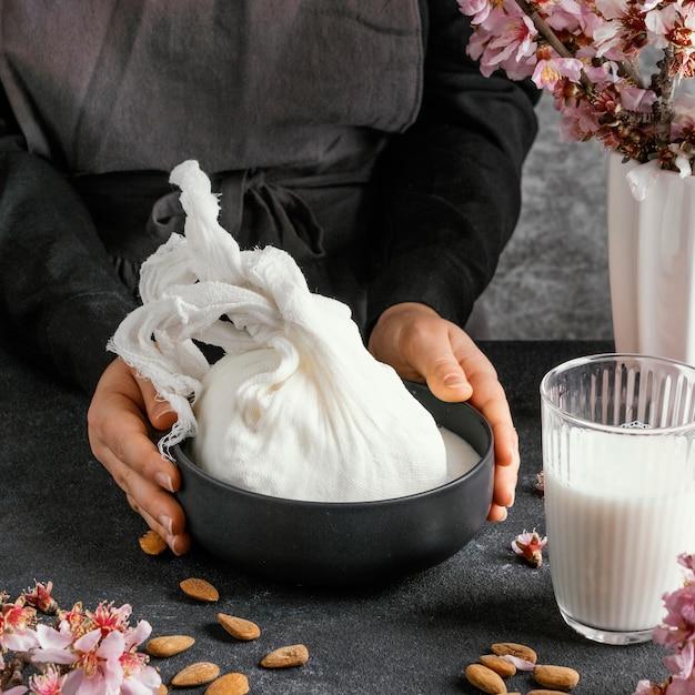 Free photo person making almond milk