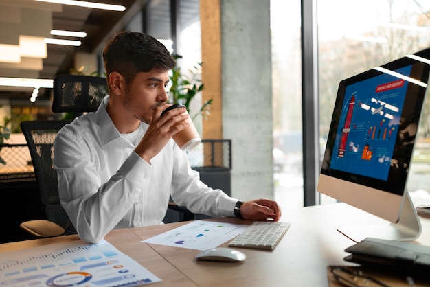 Free photo person in the office analyzing and checking finance graphs