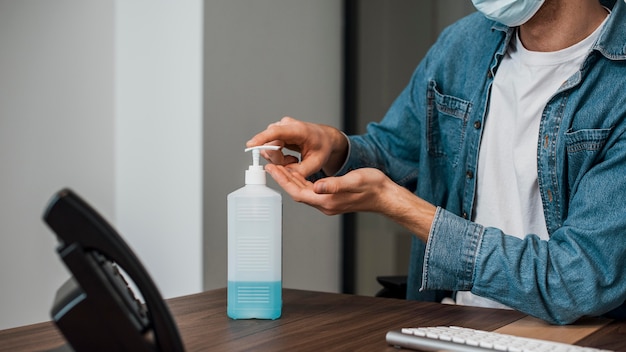 Person at the office using hand sanitizer