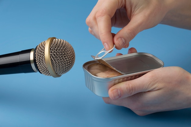 Person opening tin can close to microphone for asmr