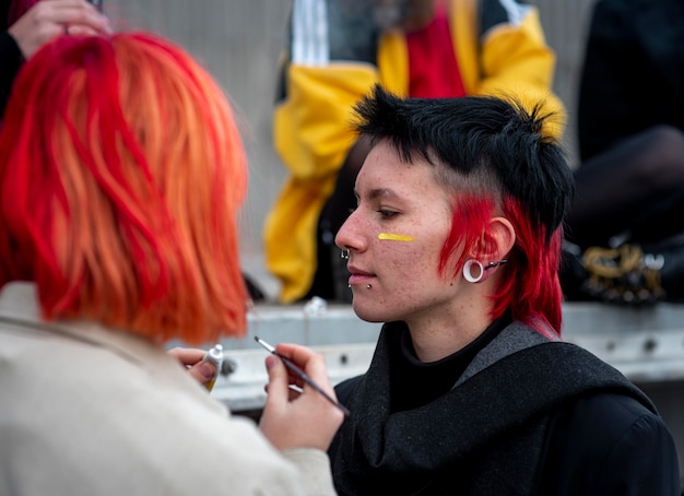 Free photo person painting a non binary flag on a friend