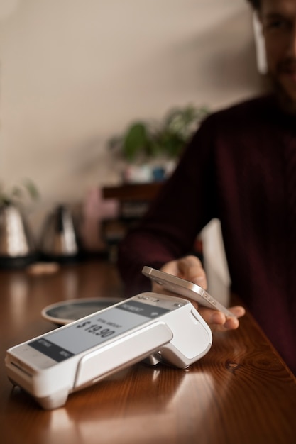 Free Photo person paying the bill at a restaurant using nfc technology