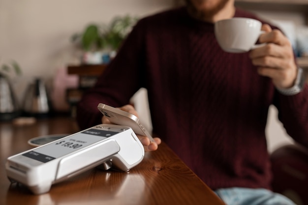 Free Photo person paying the bill at a restaurant using nfc technology