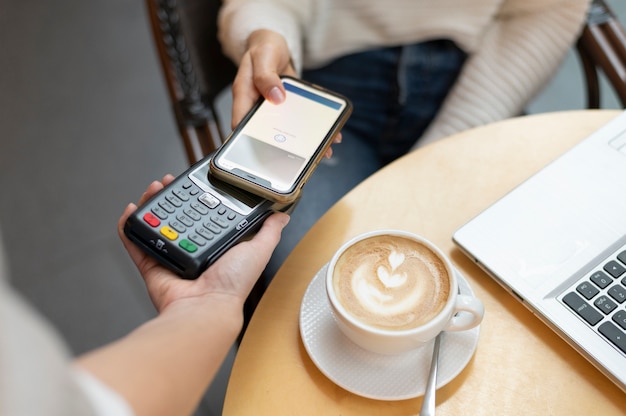 Free Photo person paying with its smartphone wallet app