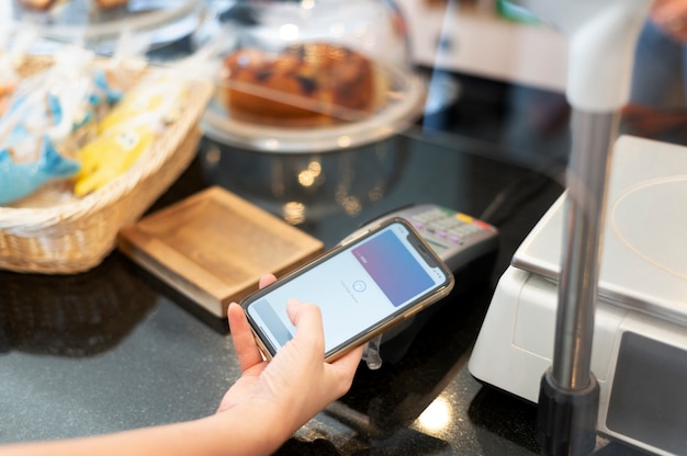 Person paying with its smartphone wallet app