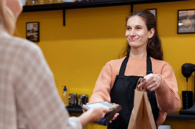 Person paying with its smartphone wallet app