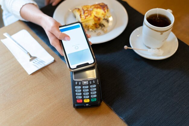 Person paying with its smartphone wallet app