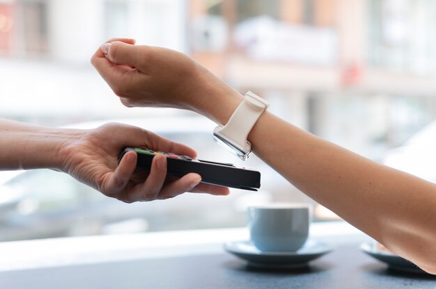 Person paying with its smartwatch wallet app