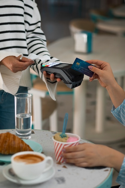 Person paying with nfc technology at a restaurant