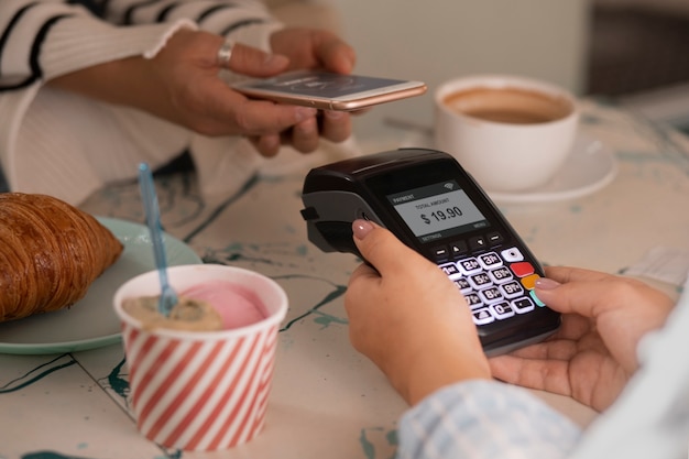 Person paying with nfc technology at a restaurant