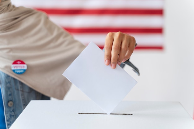 Free photo person placing its vote in a box