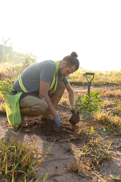 Person planting tree on the countryside