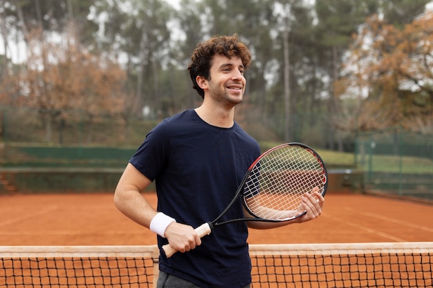 Free photo person playing tennis game in winter time