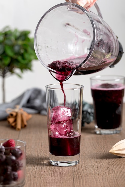 Person poring some smoothie in a glass