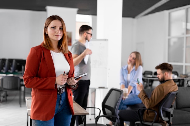 Person posing next to coworkers