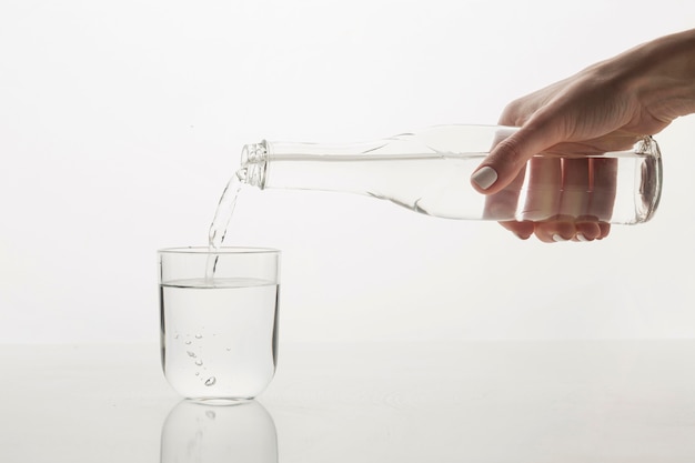 Person pouring water in glass front view