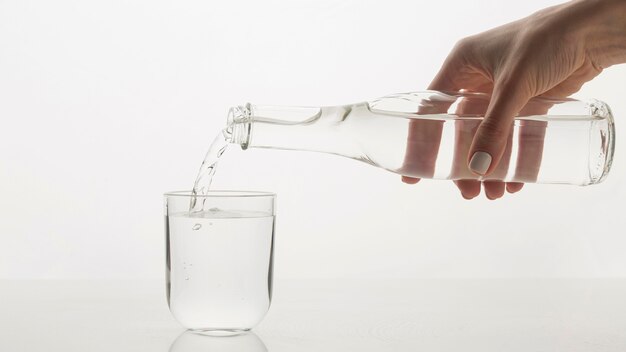 Person pouring water in glass