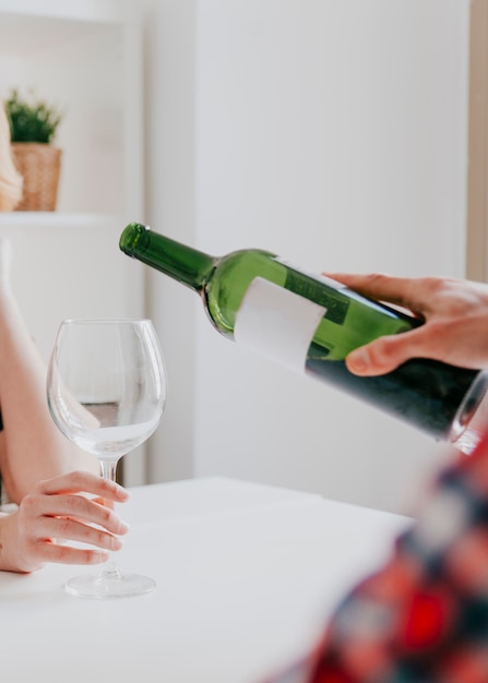 Person pouring wine to friend