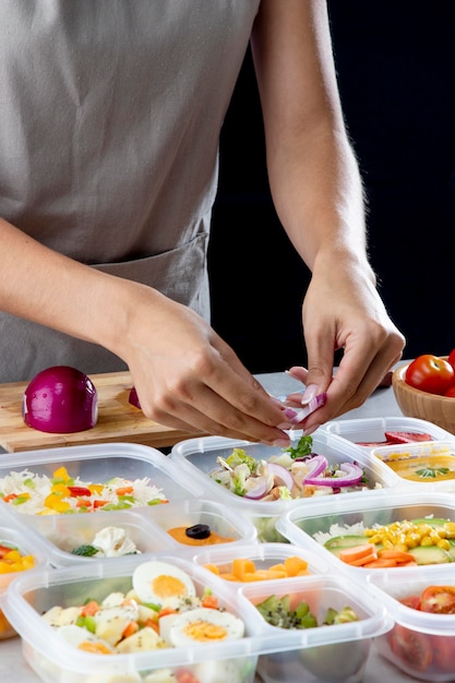 Person practicing batch cooking with healthy food