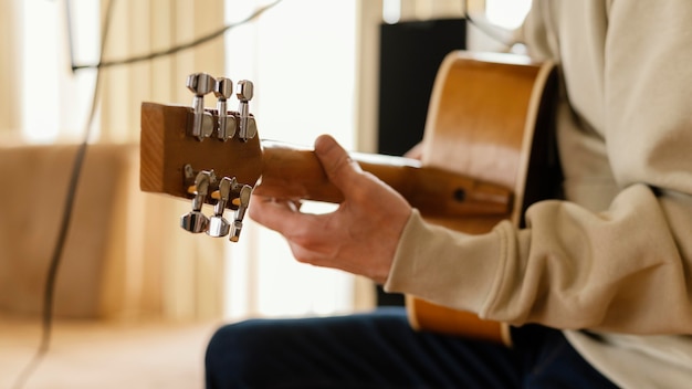 Free photo person practicing music in home studio