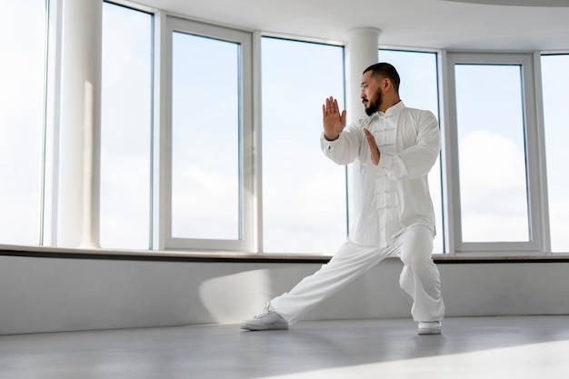 Person practicing tai chi indoors