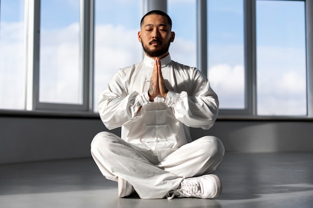 Person practicing tai chi indoors