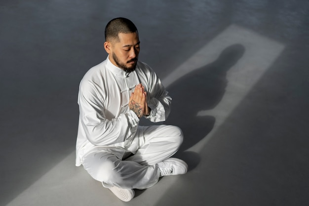 Person practicing tai chi indoors