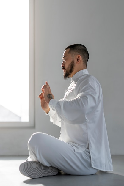 Person practicing tai chi indoors